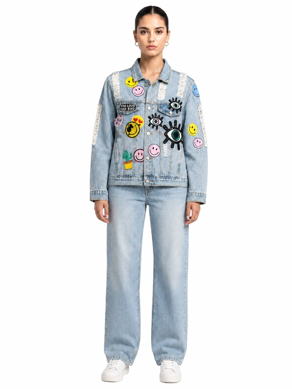 Front view of light wash denim jacket with colorful pop art embroidered patches wholesale