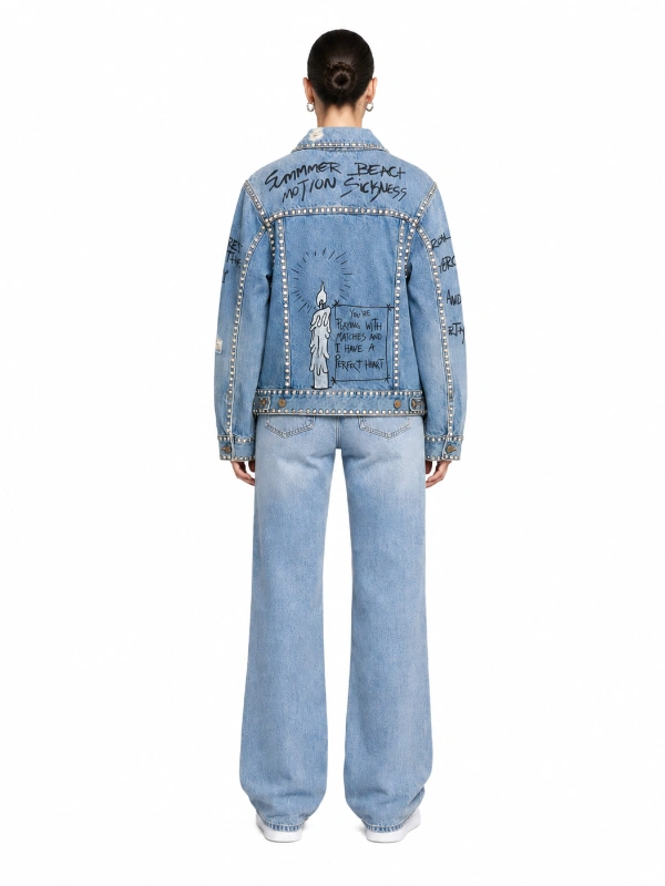 Back design of custom light wash denim jacket with graffiti print and studded details OEM