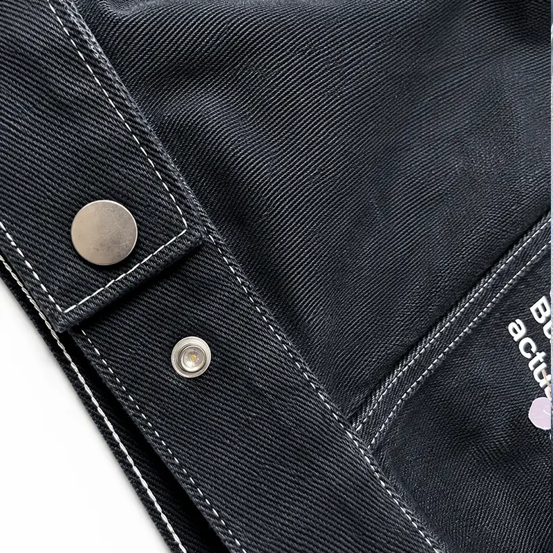 Custom metallic buttons and heavy-duty stitching on wholesale denim jacket