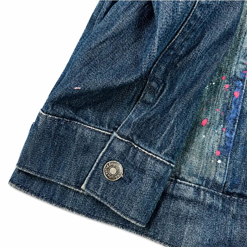 Custom paint splatter denim jacket cuff and finish details