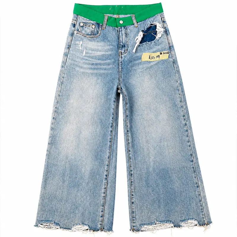 Front view of custom wide leg jeans with green waistband and distressed pocket detail