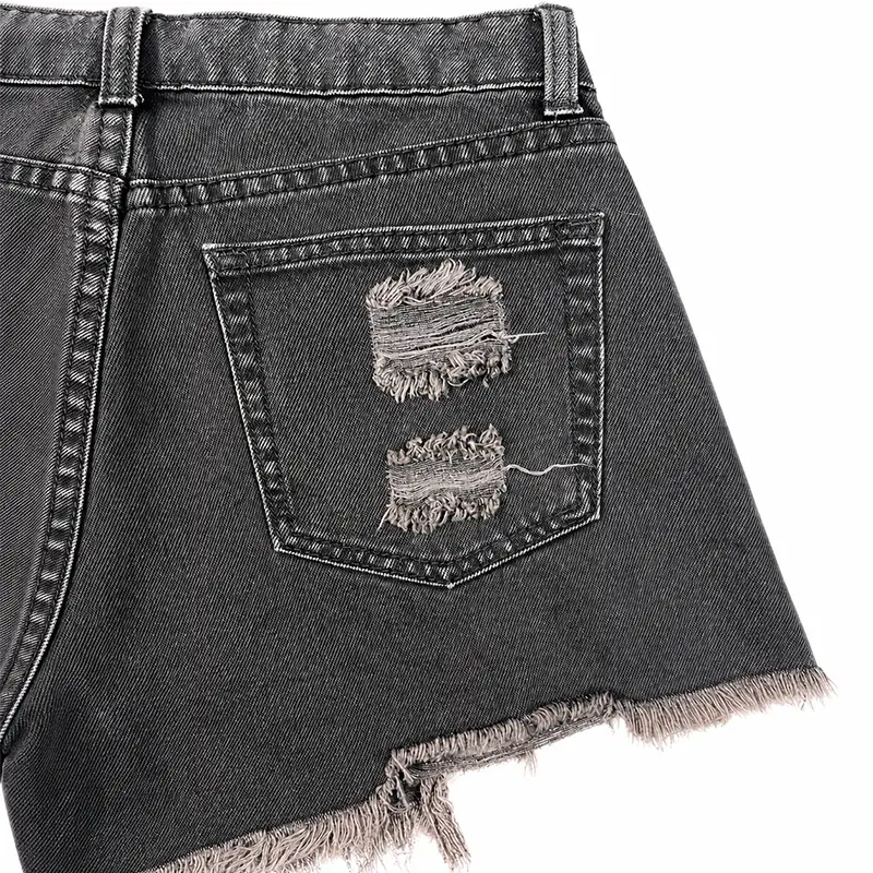 Back pocket detail of custom black distressed denim shorts with embroidery texture