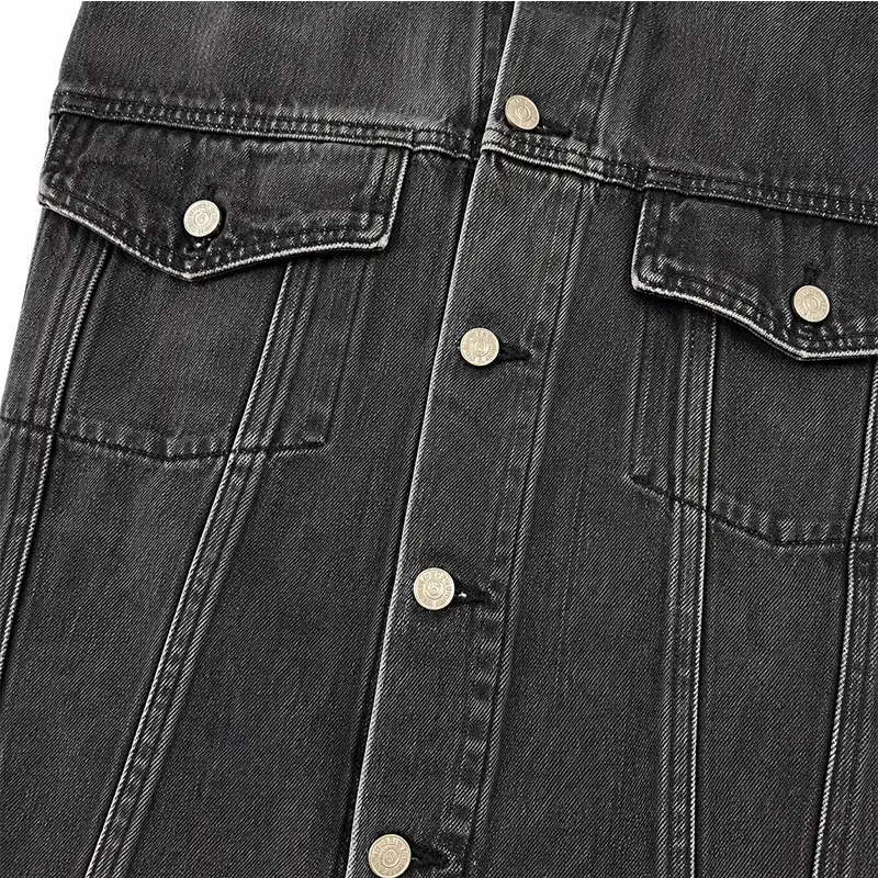 Button closure and chest pockets on custom black denim jacket manufacturer