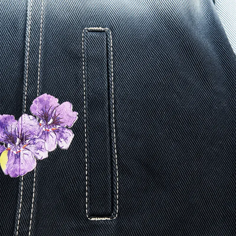 Floral print and welt pocket detailing on custom dark denim apparel