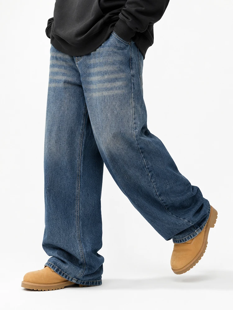 Model wearing medium wash wide leg denim jeans
