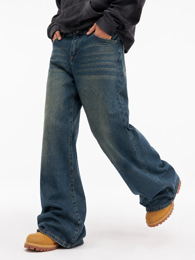Model walking in dark blue wide leg denim jeans